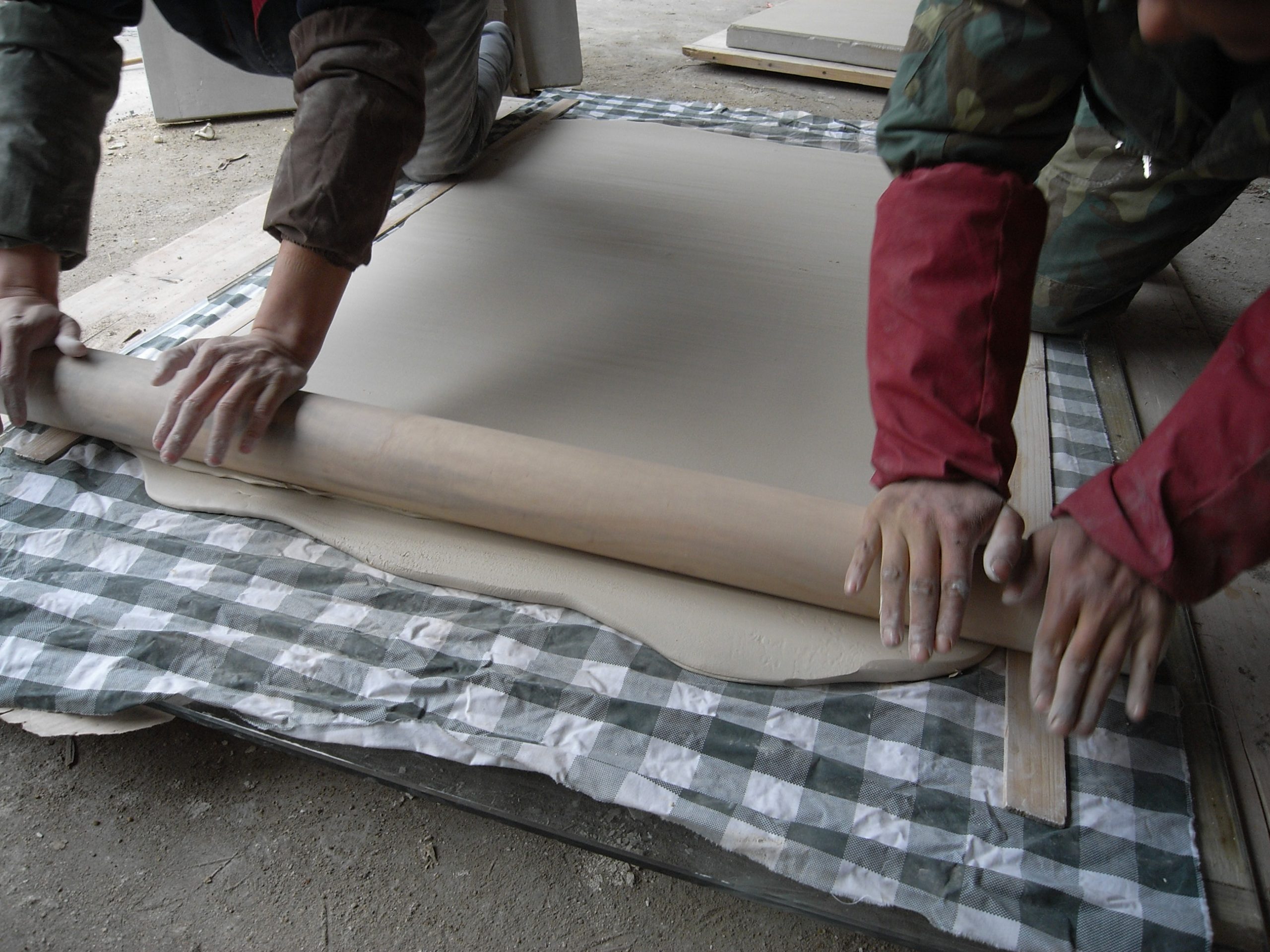Studio assistants rolling out clay in Lin Jianhua's studio. Photo courtesy of the artist.