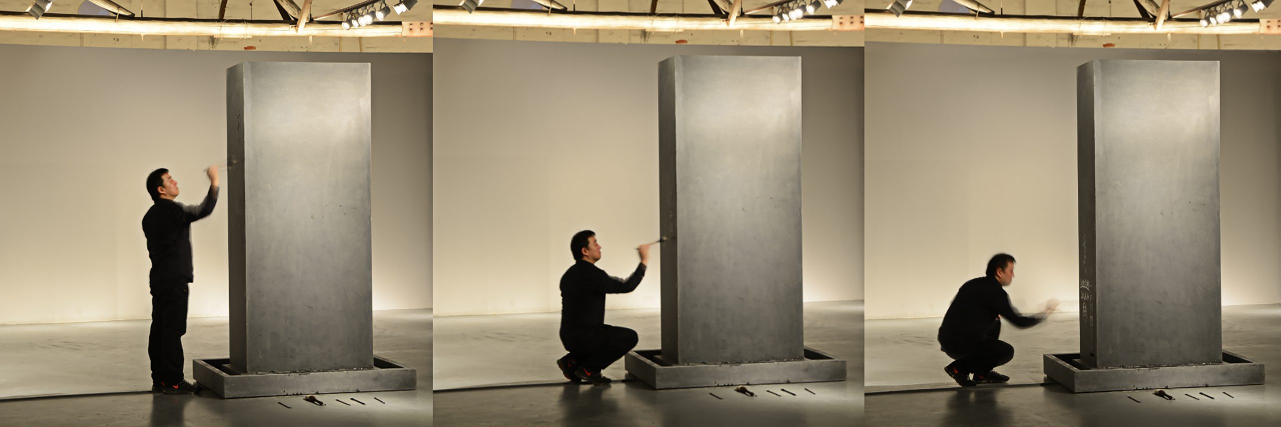 Song Dong painting in water on his work Traceless Stele, 2016. Photo ©️ Song Dong