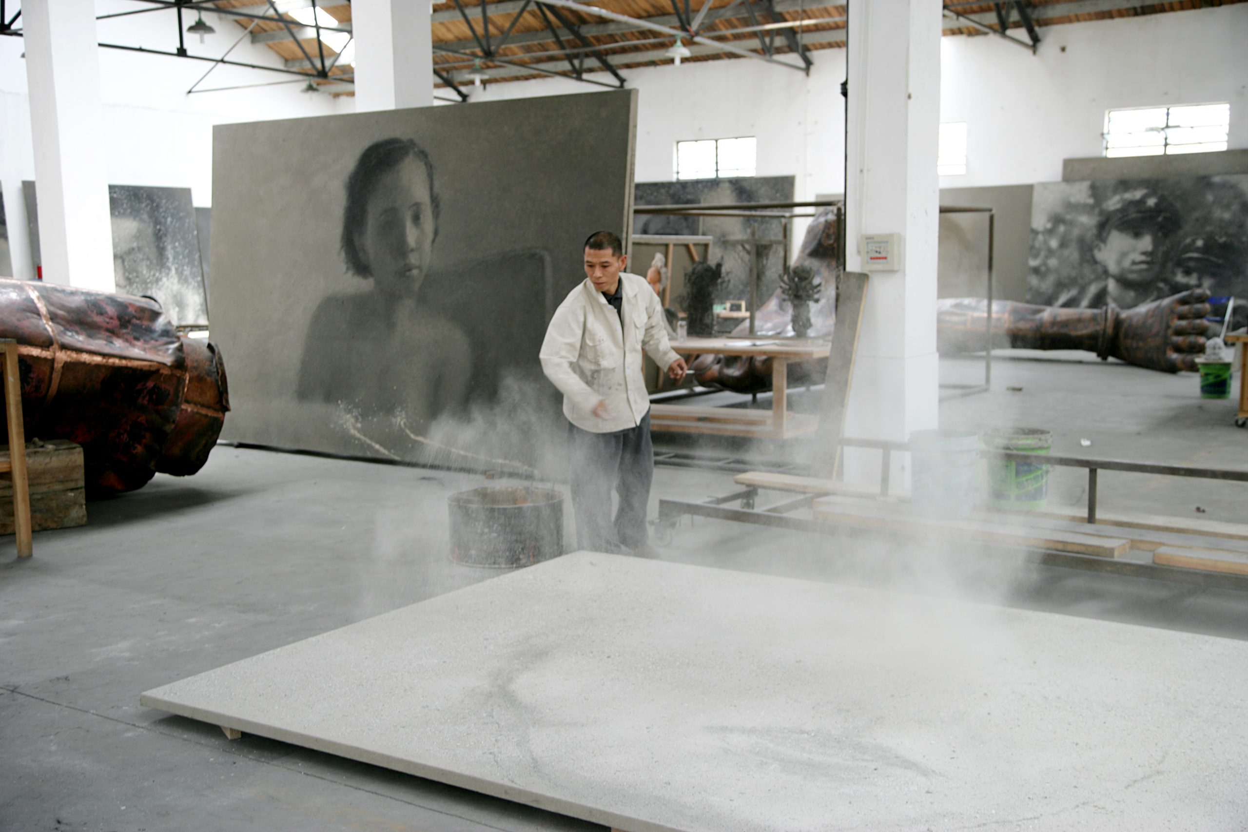 Zhang Huan applying ash to a painting. Photo courtesy of the artist and Pace Gallery.