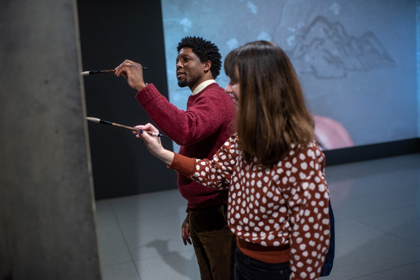 Visitors to the Smart Museum use water and brushes to write on Song Dong's Traceless Stele.